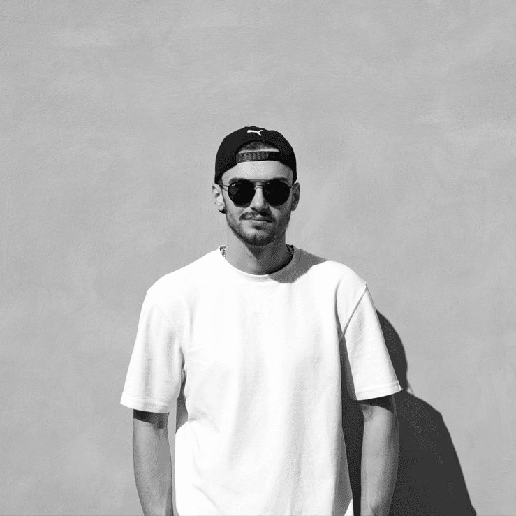 black and white picture of Ryan Gregory wearing sunglasses and a cap